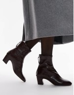 leather heeled boots in burgundy
